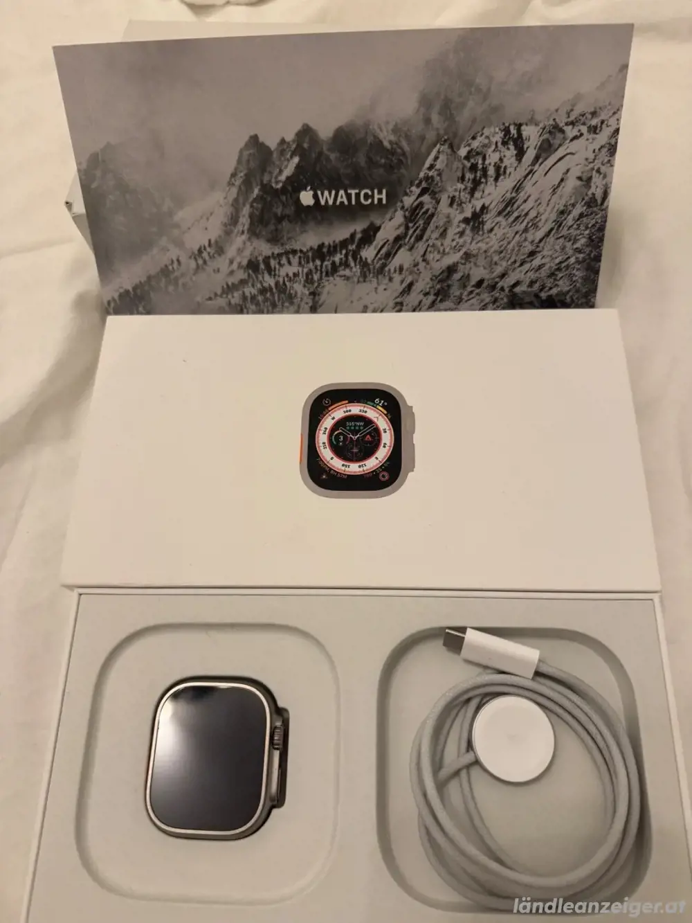 Apple Watch Ultra 49 mm Titangehäuse mit Starlight Alpine Loop, groß (GPS+.)