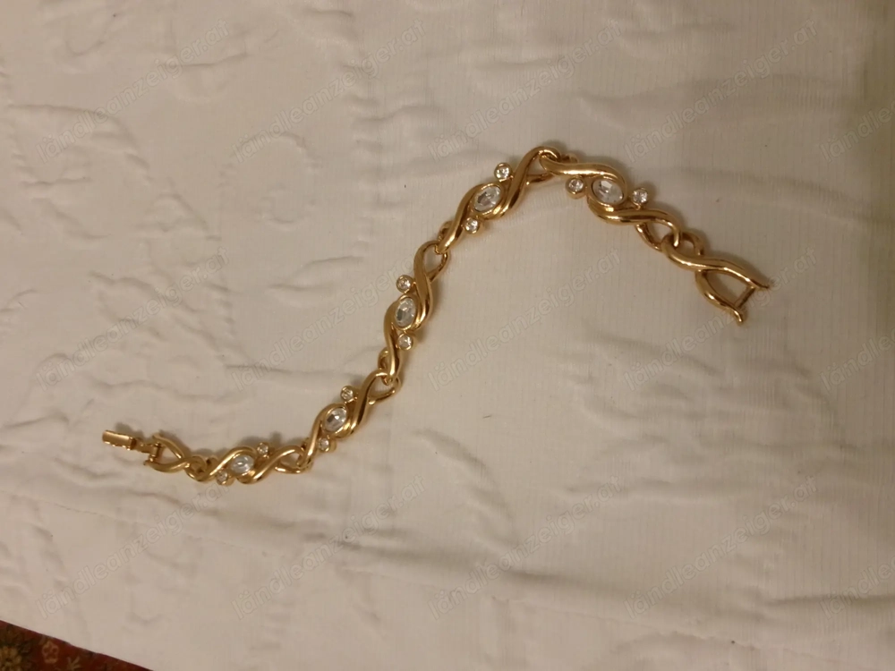  Armband goldfarben mit weißen Steinen