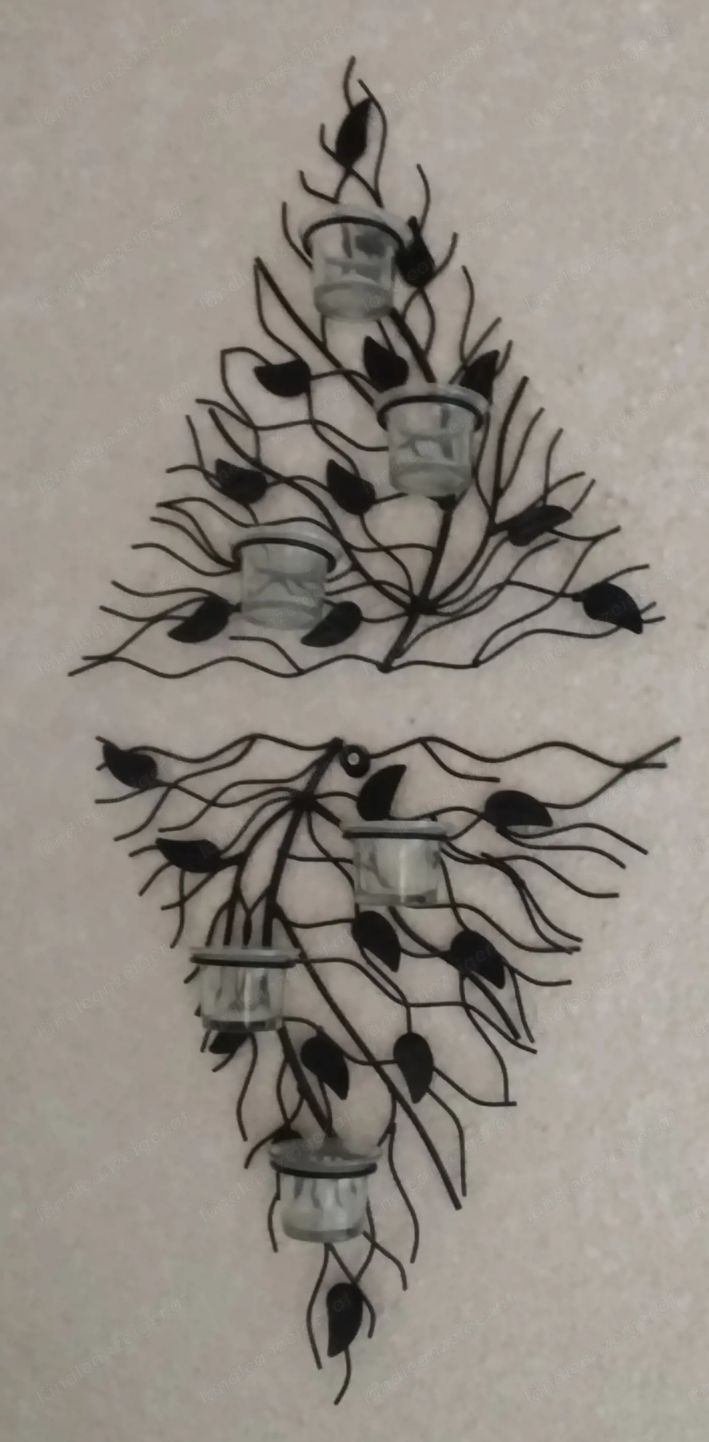 Wanddeko aus Metall mit Kerzenhalter