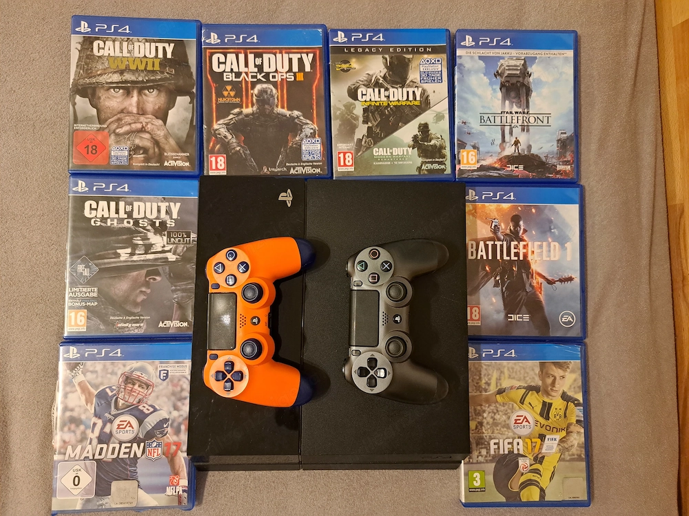 PS4 Konsole (schwarz) mit 2 DualShock 4 Controllern, allen Kabeln und 8 Top-Spielen (CoD, Battlefiel