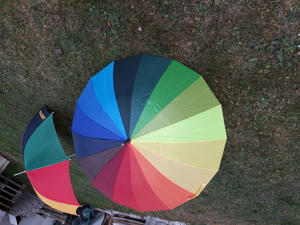 Zwei große regenbogenfarbige Regenschirme Bild 2