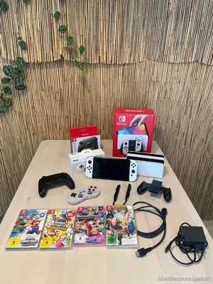 Nintendo OLED mit videospiel und Zubehör in verpakung 