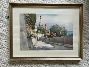 Aquarell Küstenstraße mediterran mit blühenden Bäumen und Kirchtürmen samt Rahmen