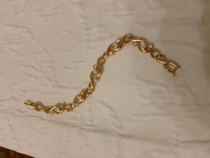  Armband goldfarben mit weißen Steinen